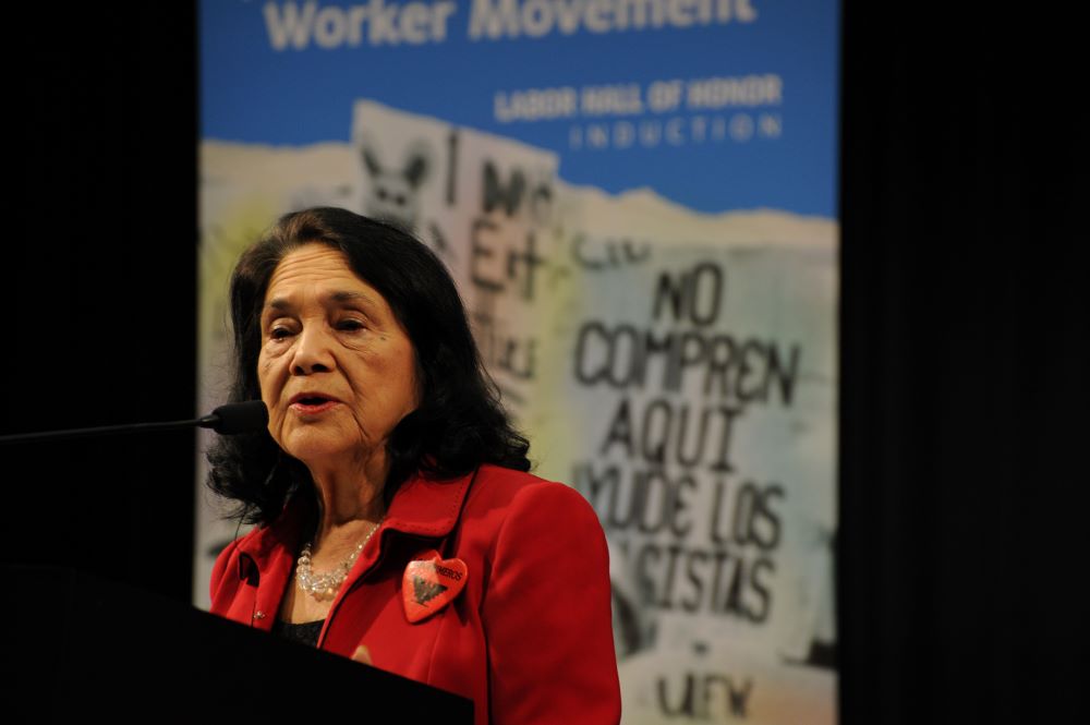 Dolores Huerta speaking at a podium