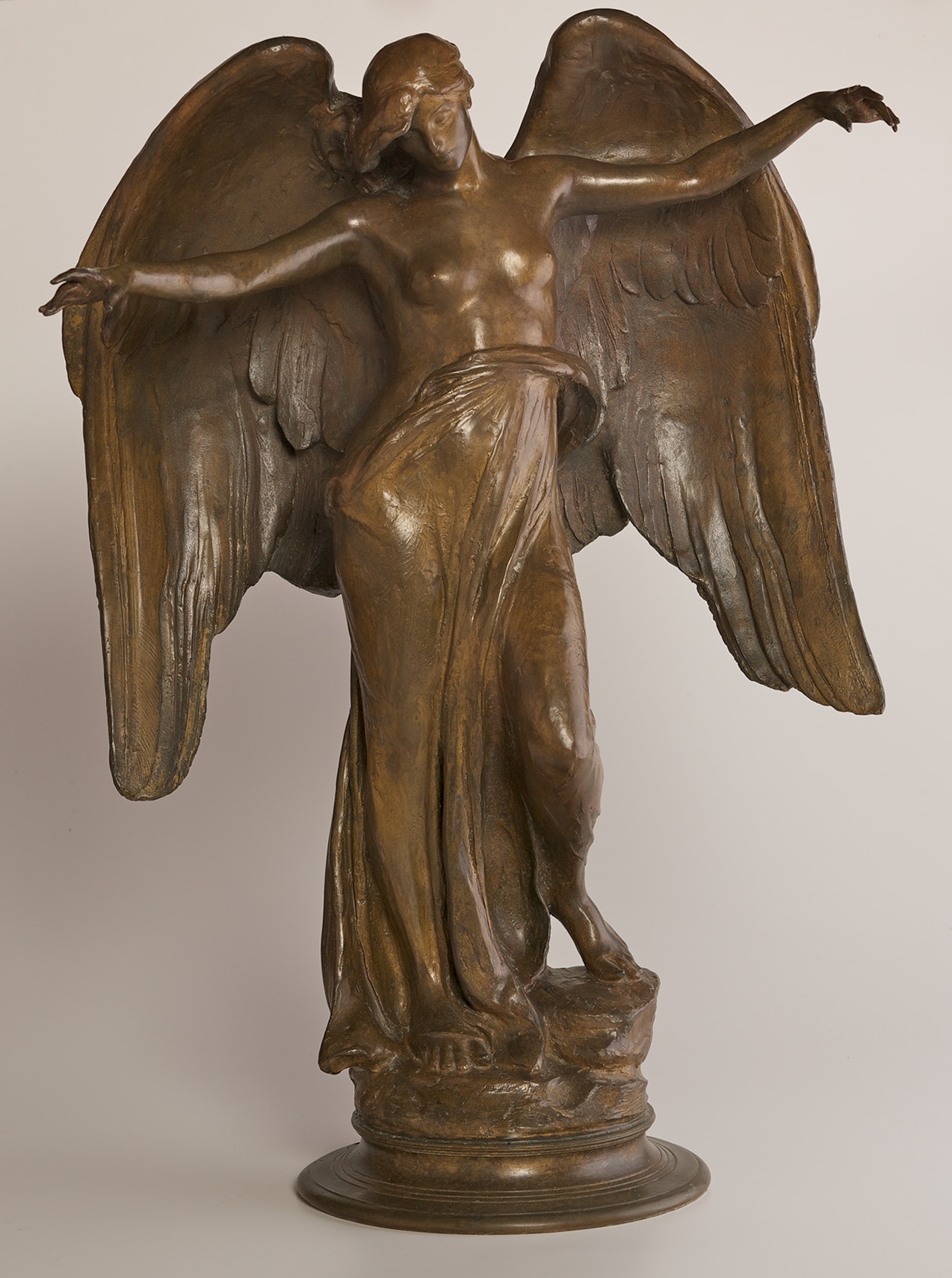 An angel-like figure with large wings holding out her arms to the side.