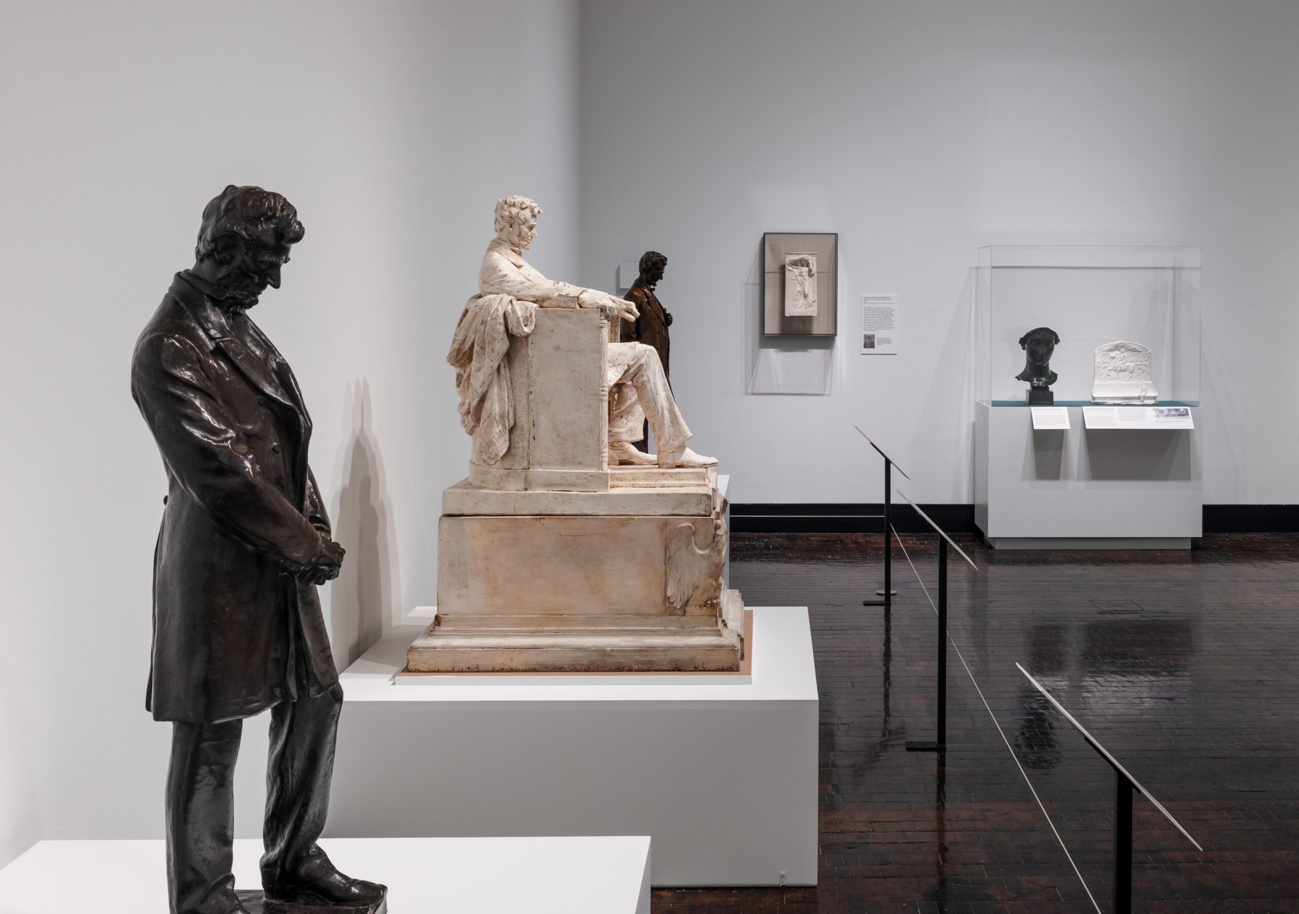 Three statues of Abraham Lincoln in a gallery