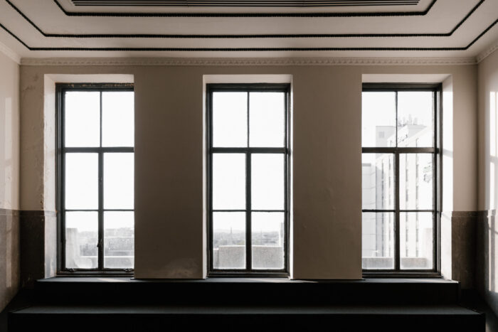Three vertical windows with light streaming in