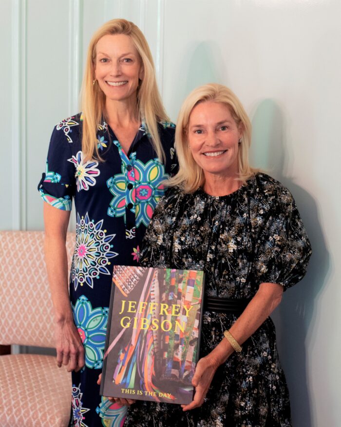 Delphine Damon and Cathy Grier holding a Jeffrey Gibson catalogue