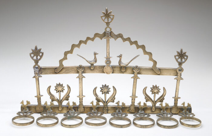 A Hanukkah Lamp with birds and suns.