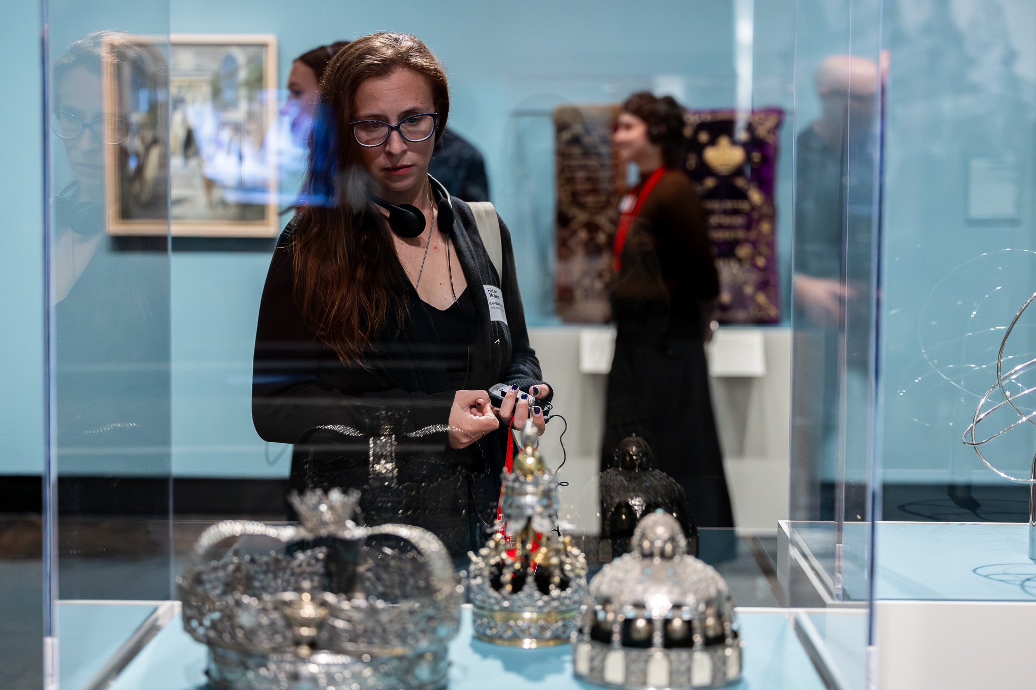 Woman looking at art objects in a case