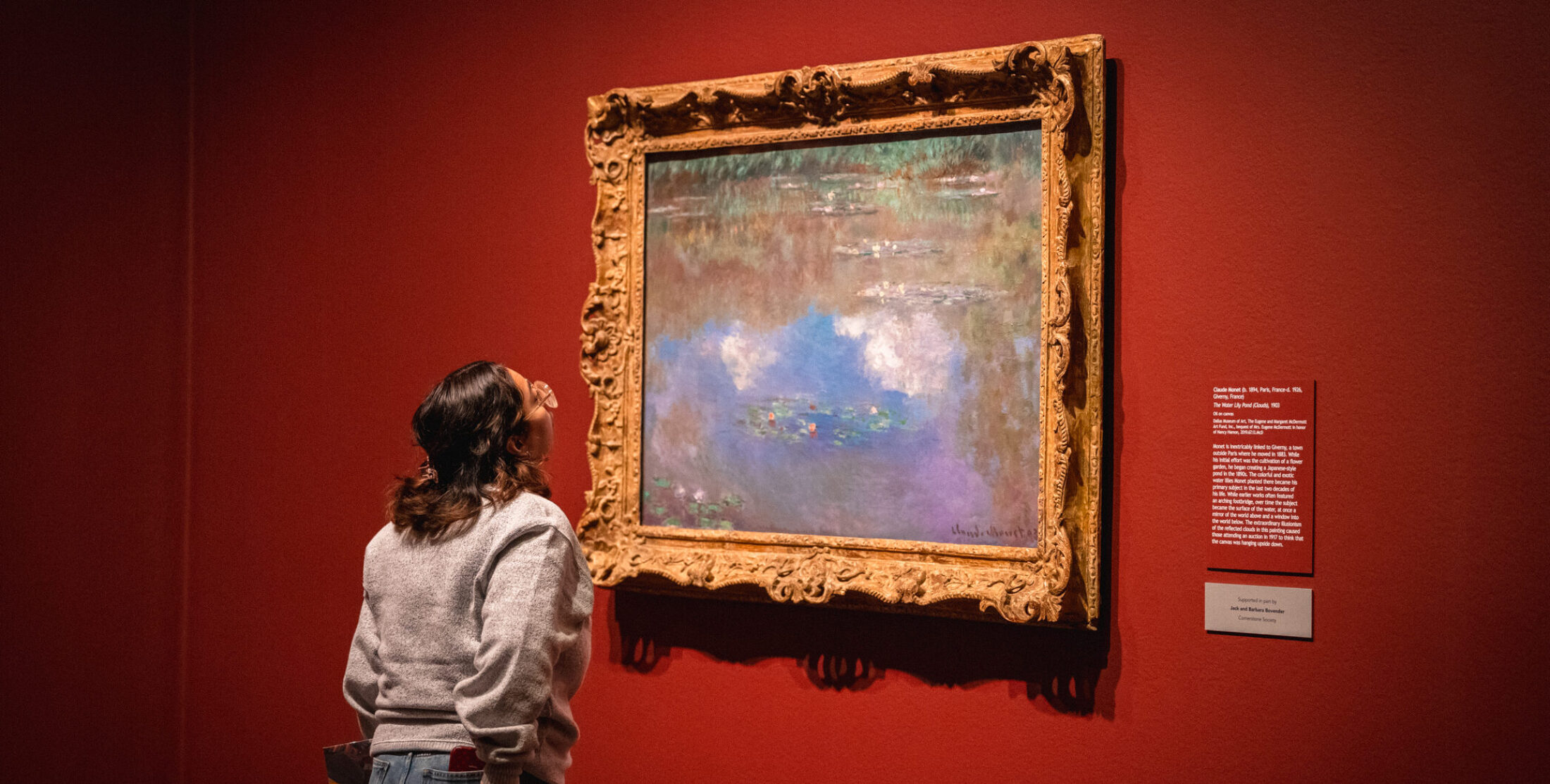 Woman looking at an impressionism painting by Claude Monet