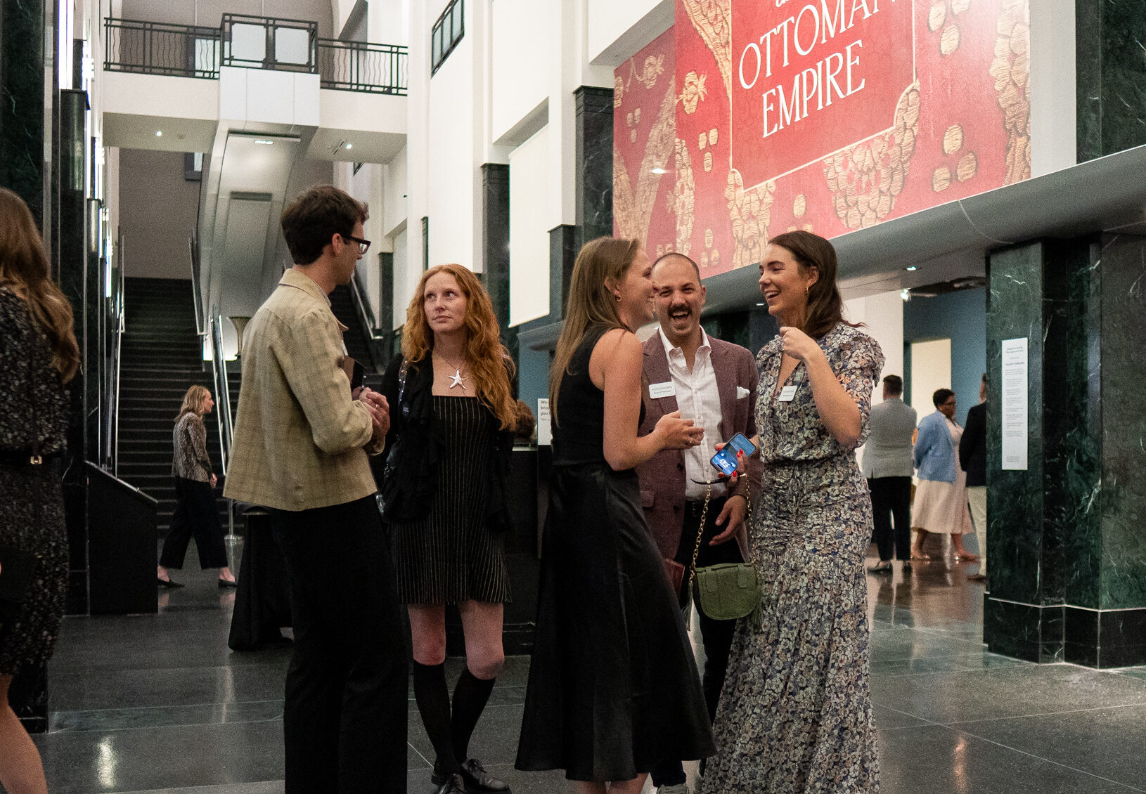 People socializing in front of the Venice and the Ottoman Empire exhibition entrance