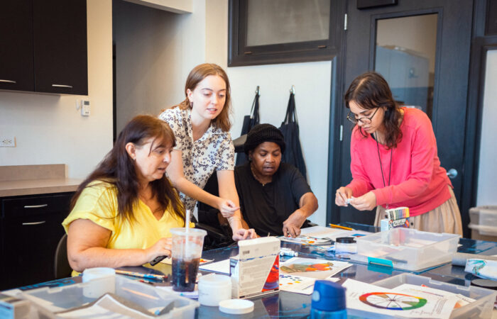 Group of women make art together during a class.