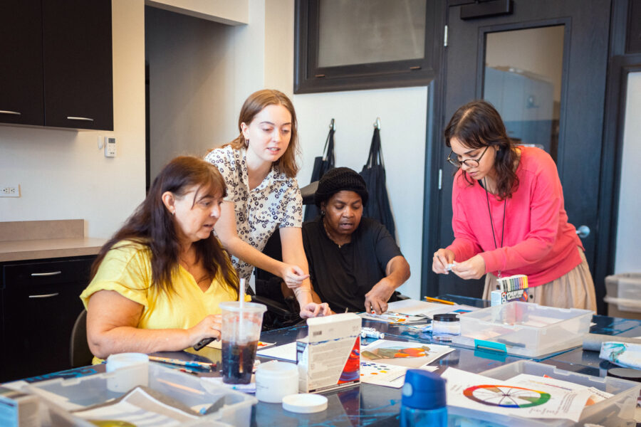 Group of women make art together during a class.