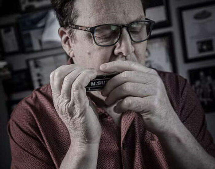 Tim Gartland playing the harmonica