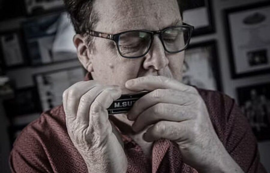 Tim Gartland playing the harmonica