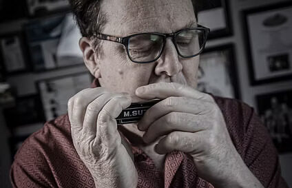 Tim Gartland playing the harmonica