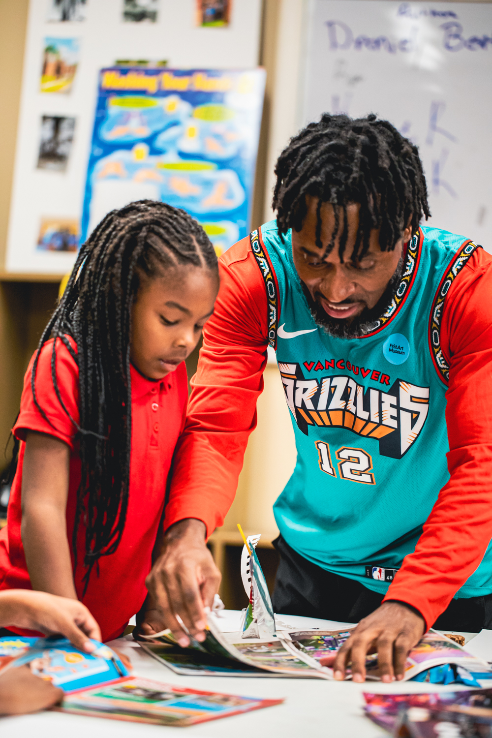 Artist Tay Butler working with Edgehill Brighter Days students on a collage project in September 2023
