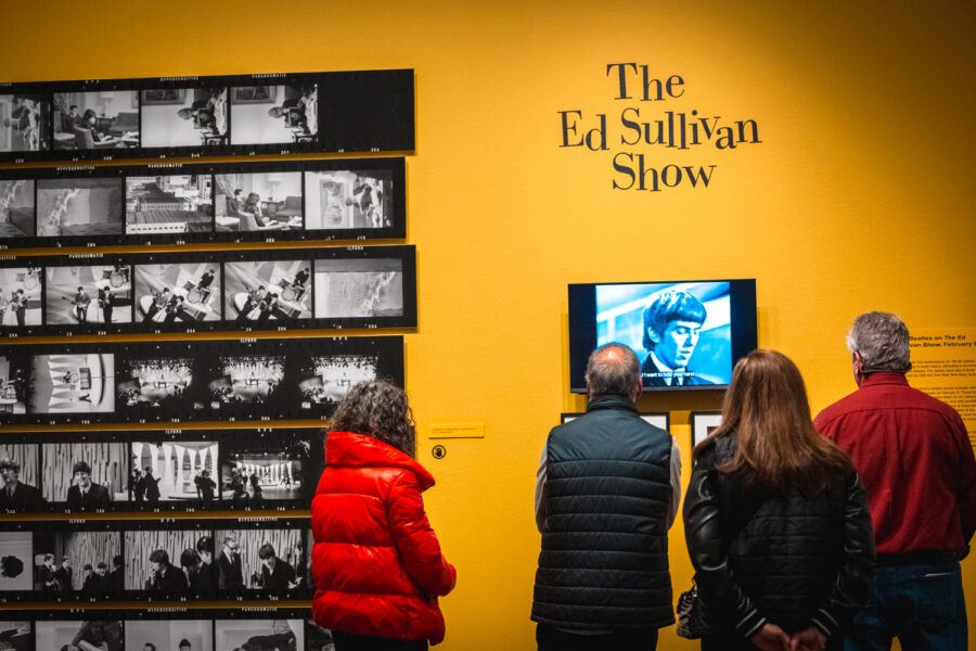 Guests watching a video screen with the words 