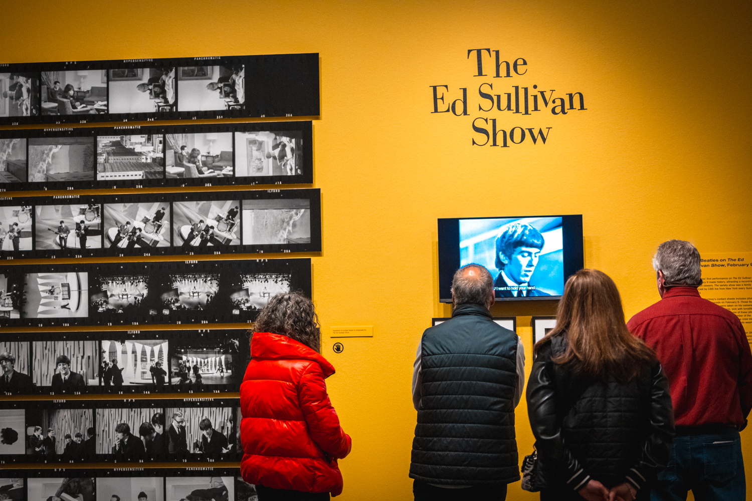 Guests watching a video screen with the words 