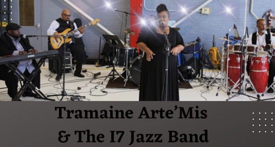 The band Tramaine Arte'Mis & The 17 Jazz Band perform on a stage.