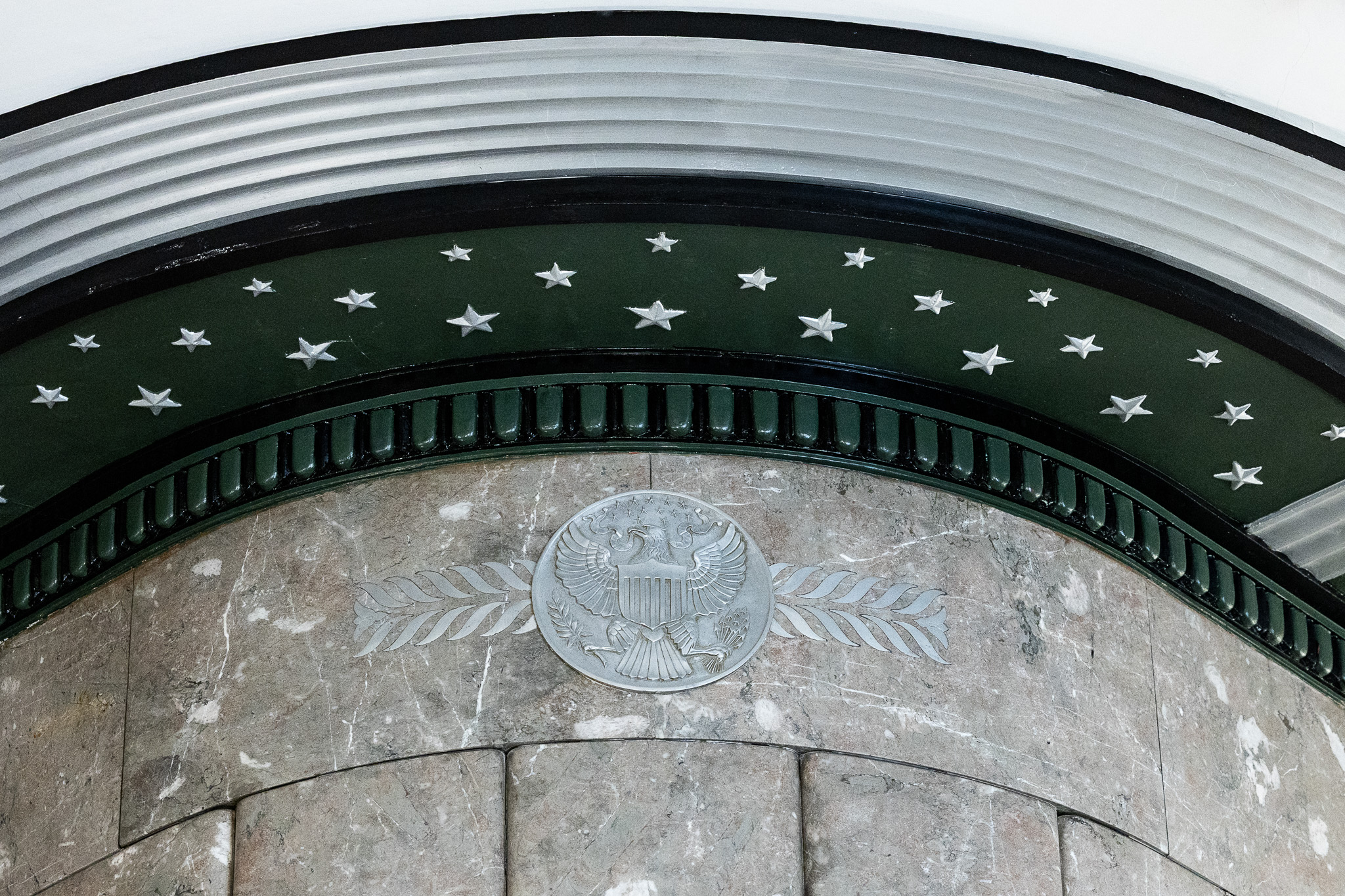 Close up of an archway with green trim and silver stars.