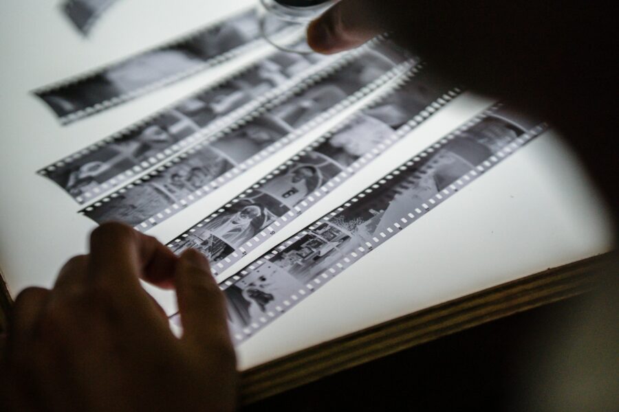 A person's hands are holding film strips.