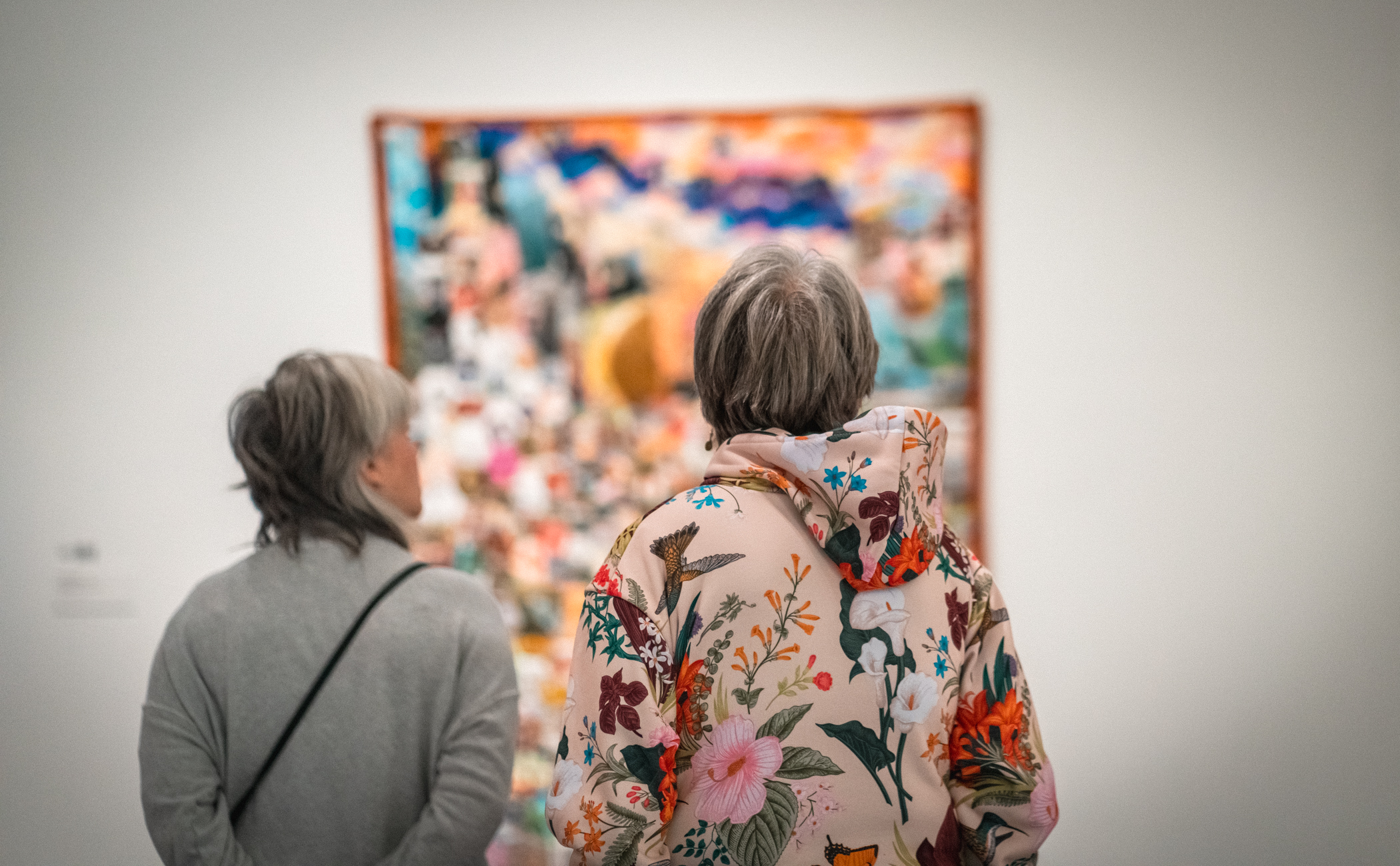 Two women look at a quilt.