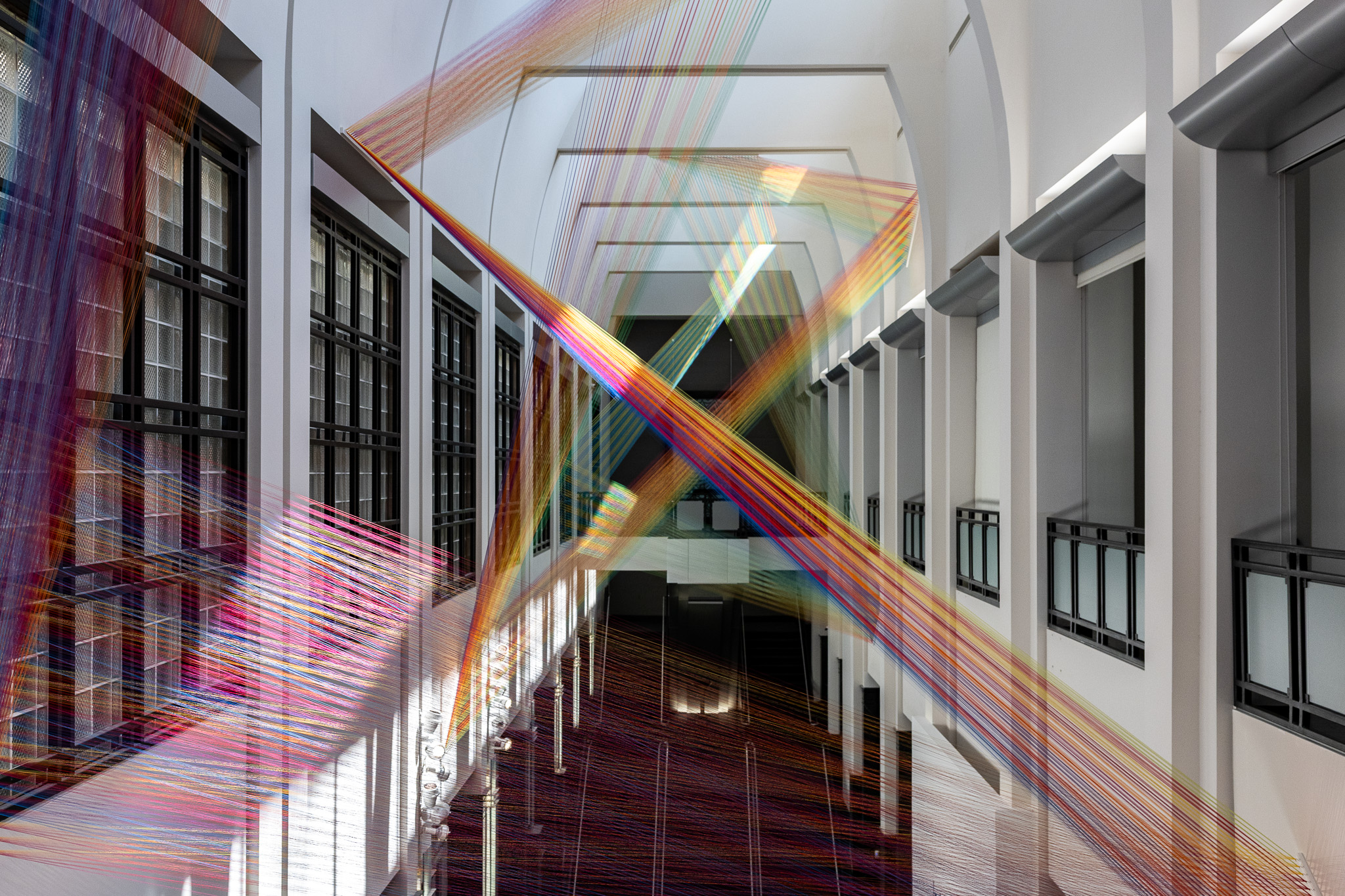 Colored threads zigzagging across the Frist atrium.