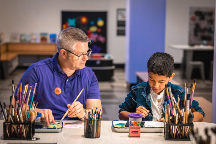 Father and son painting together