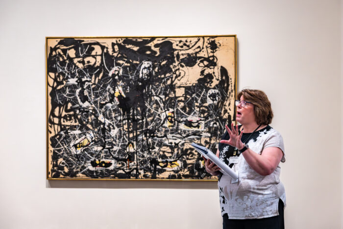 Woman explains about painting.