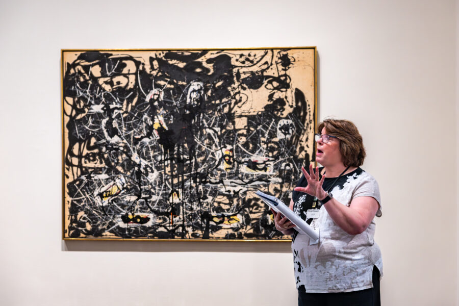 Woman explains about painting.
