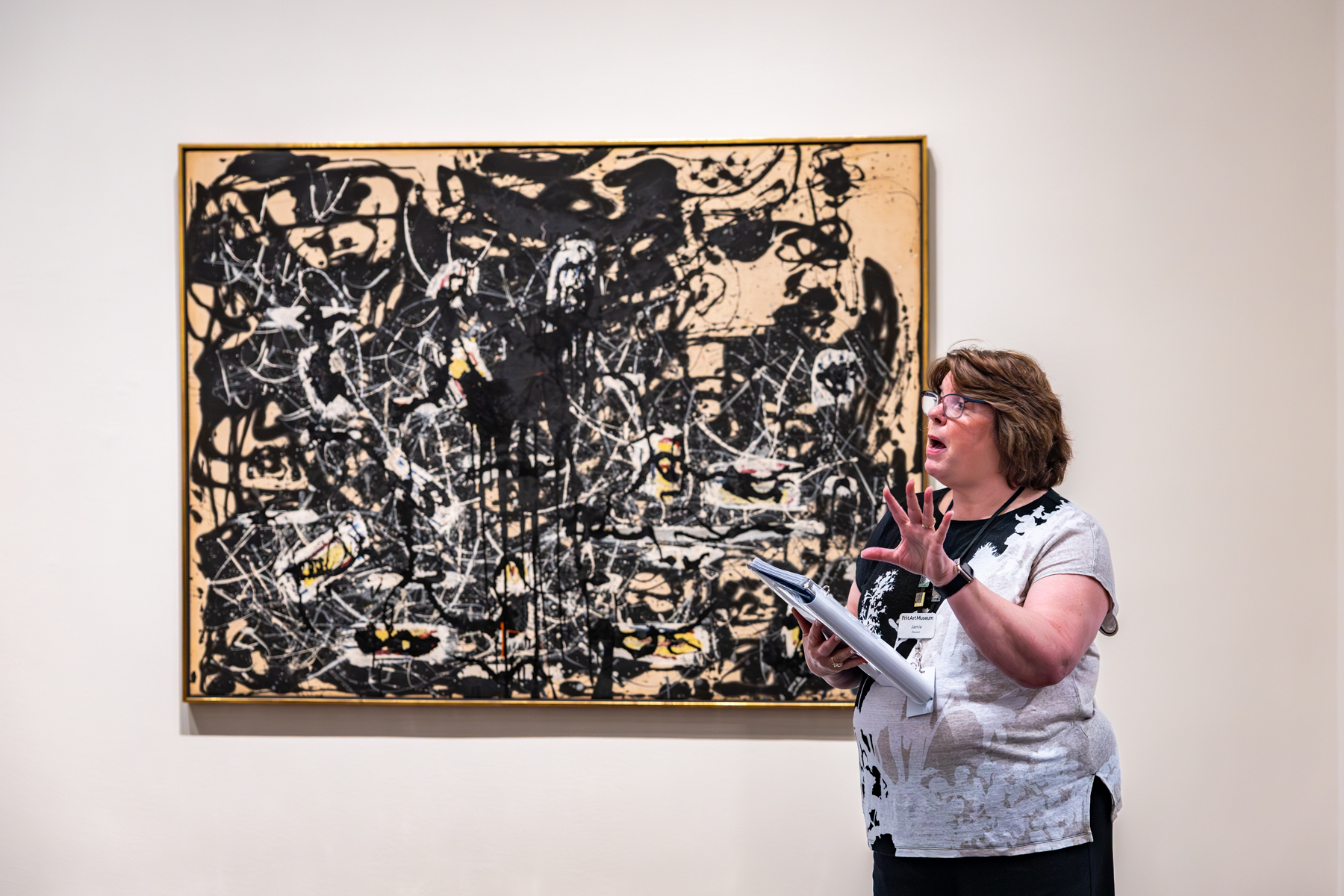 Woman explains about painting.