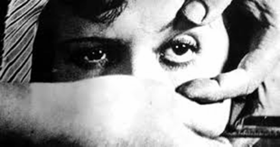 A black and white photo of someone's hands holding another person's eyes open.