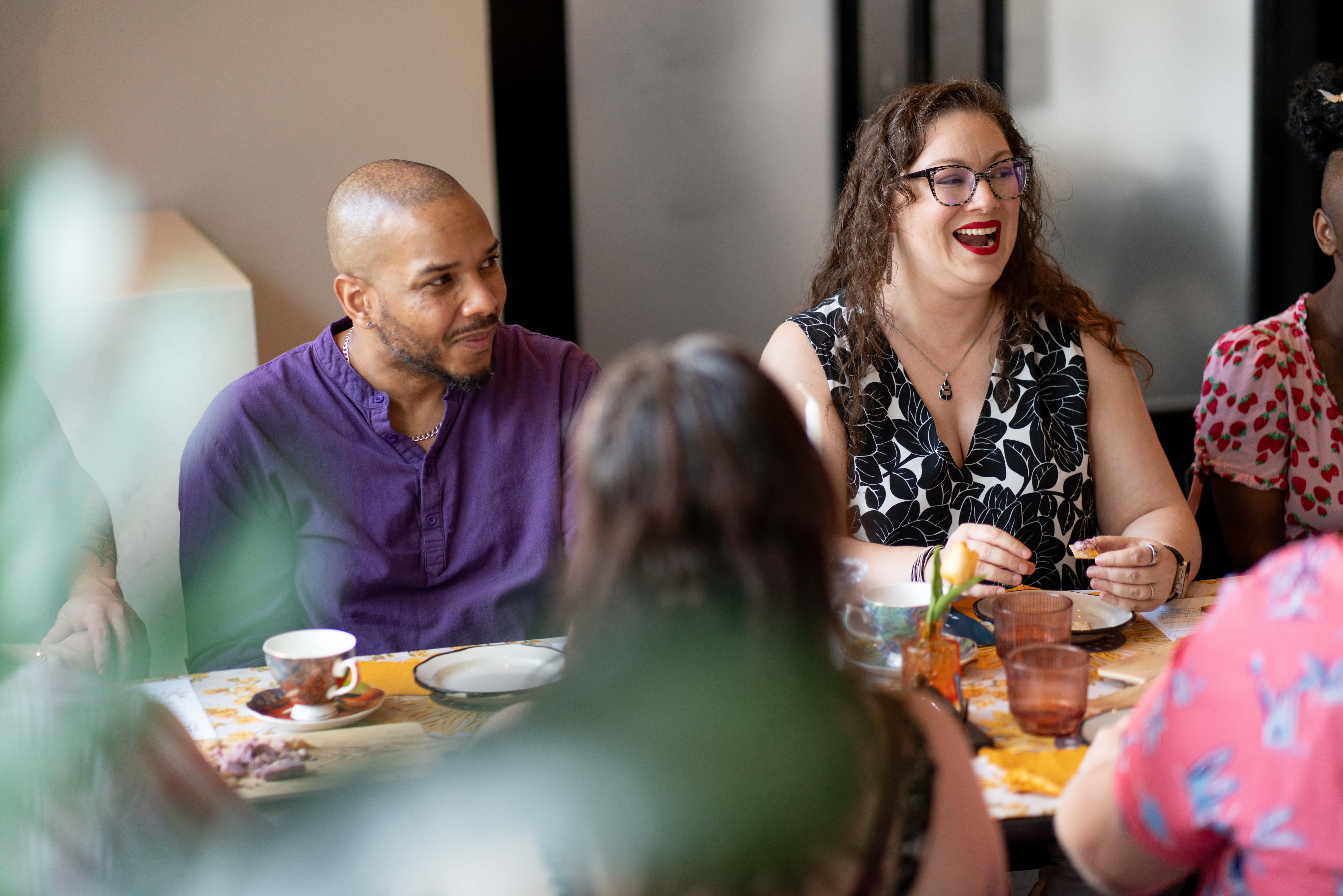 A couple of people enjoy a tea in a café.