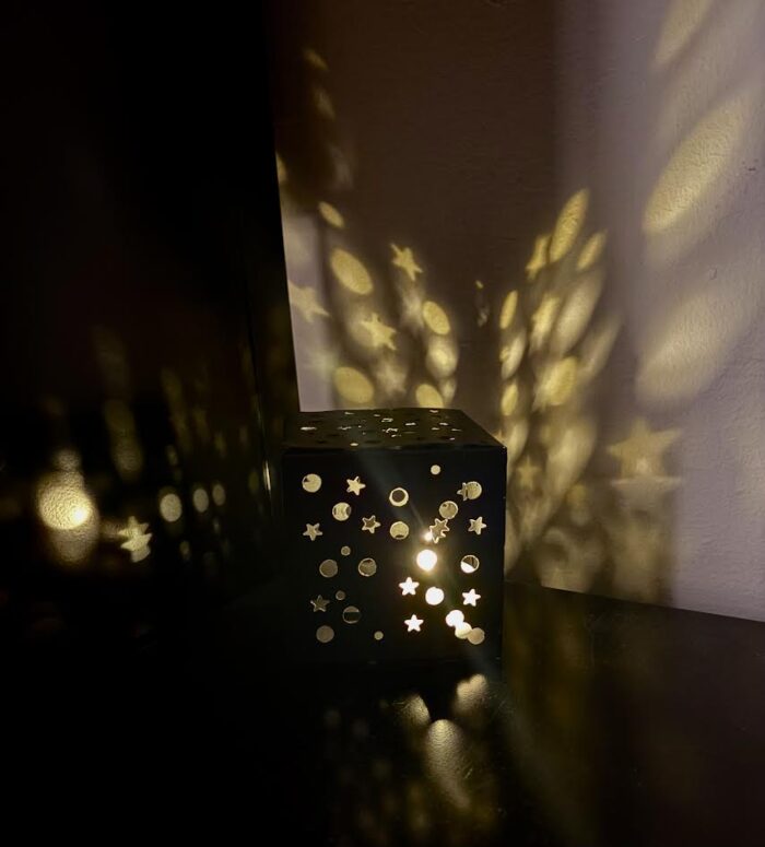 A hand-made light-box with circle and star shapes. 