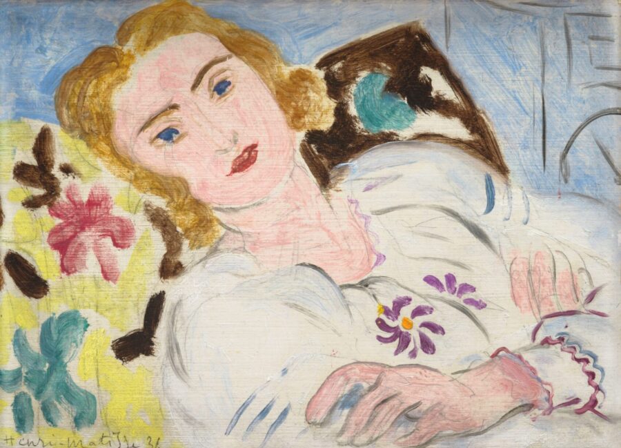 A painting of a woman in a white blouse reclines on a pillow.