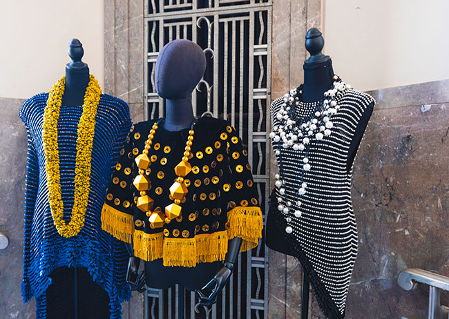 Three mannequins with coloful tops and chunky jewelry by Jianhui