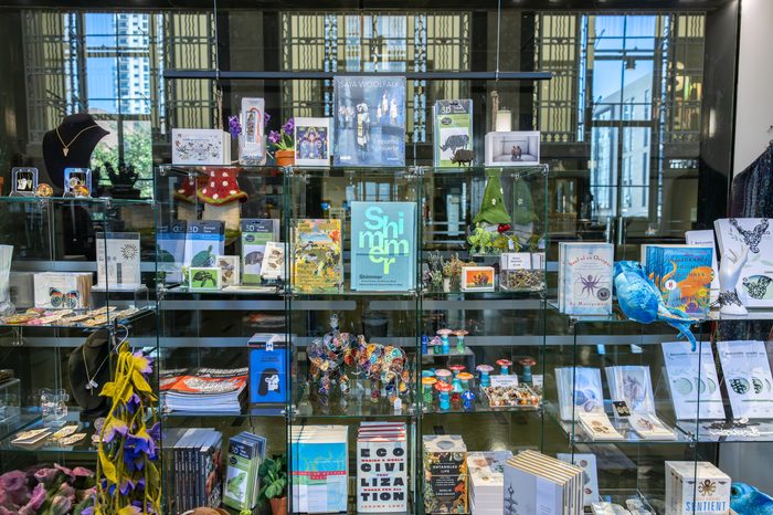 A store display of various gift items on glass shelves.