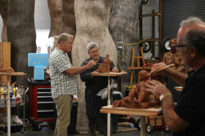 Alan LeQuire helps a man work on a small sculpture