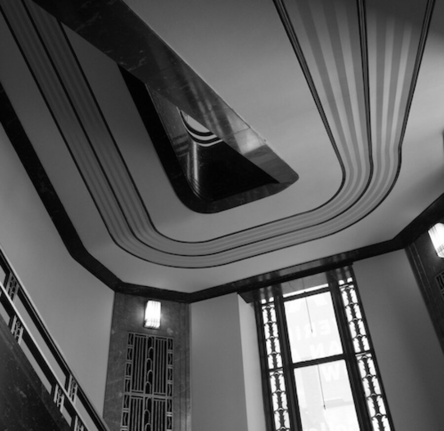 black and white photograph taken under one of the staircases at the Frist showing art deco details and lines