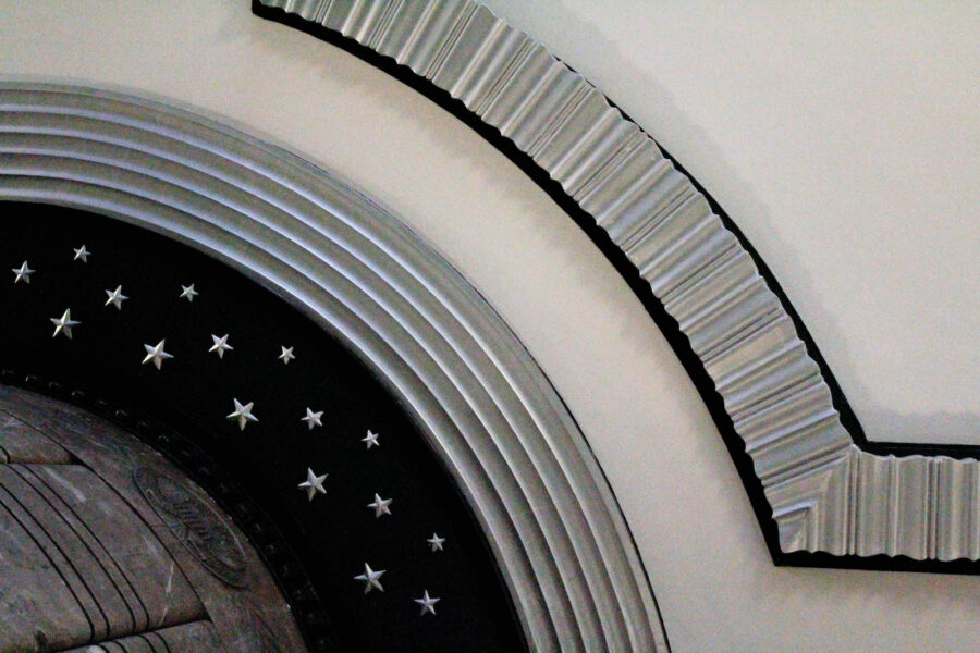 This is an image of architecture in the Frist building. The image depicts curves in the structure of the building, which include stars, ridges, and various textures. The image contains grays, blacks, and whites.