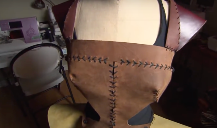 handmade top on a mannequin made of leather with straps over the shoulders