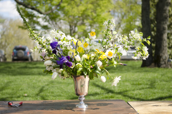 Floral arrangement in a metal vase.
