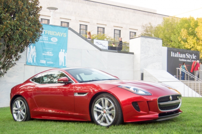 Red sports car on the grass in front of the Frist building