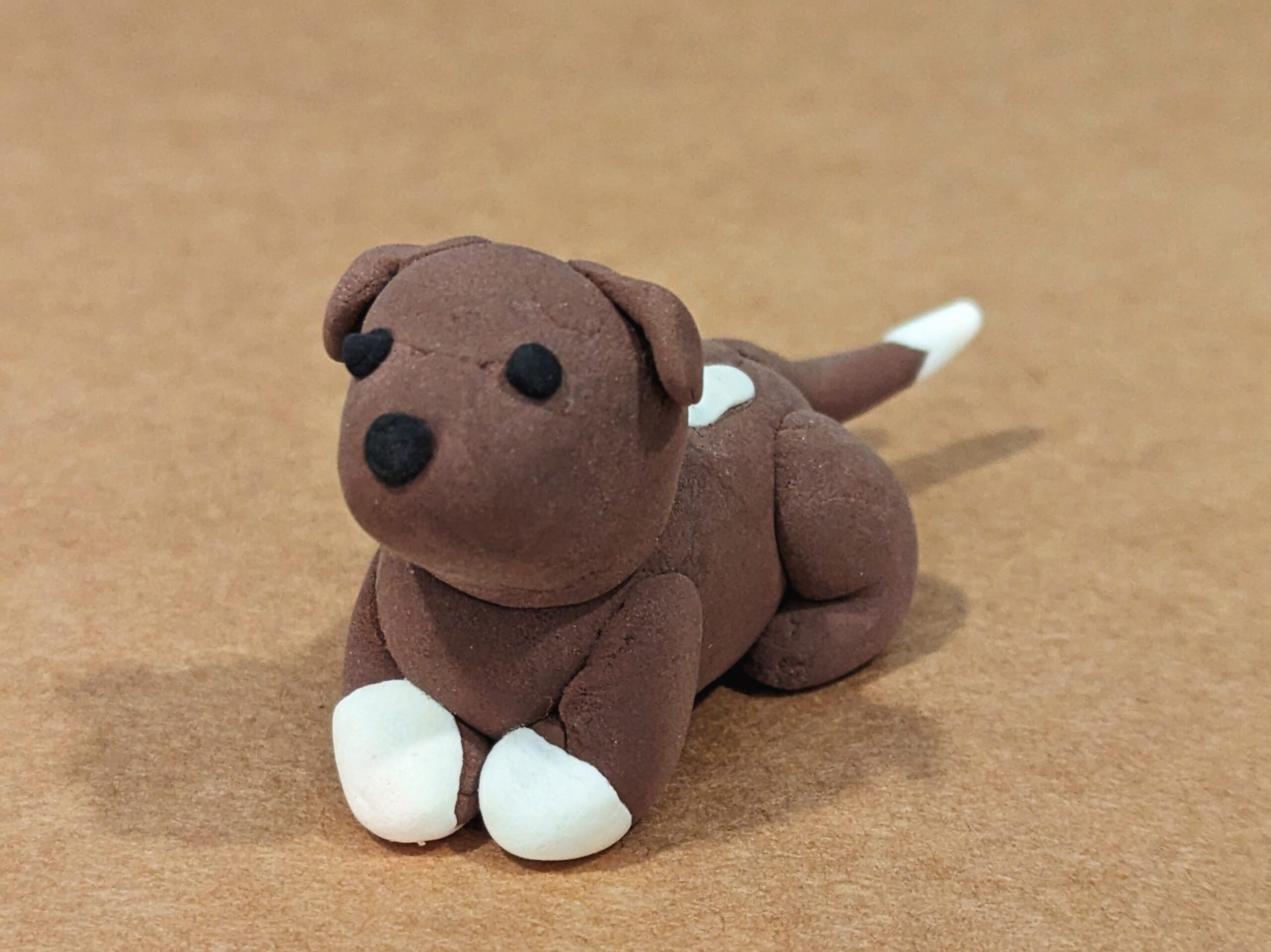 Brown and white dog sculpture made from Model Magic clay.