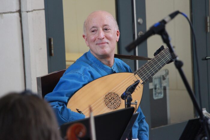 Francis Perry holding a lute smiling