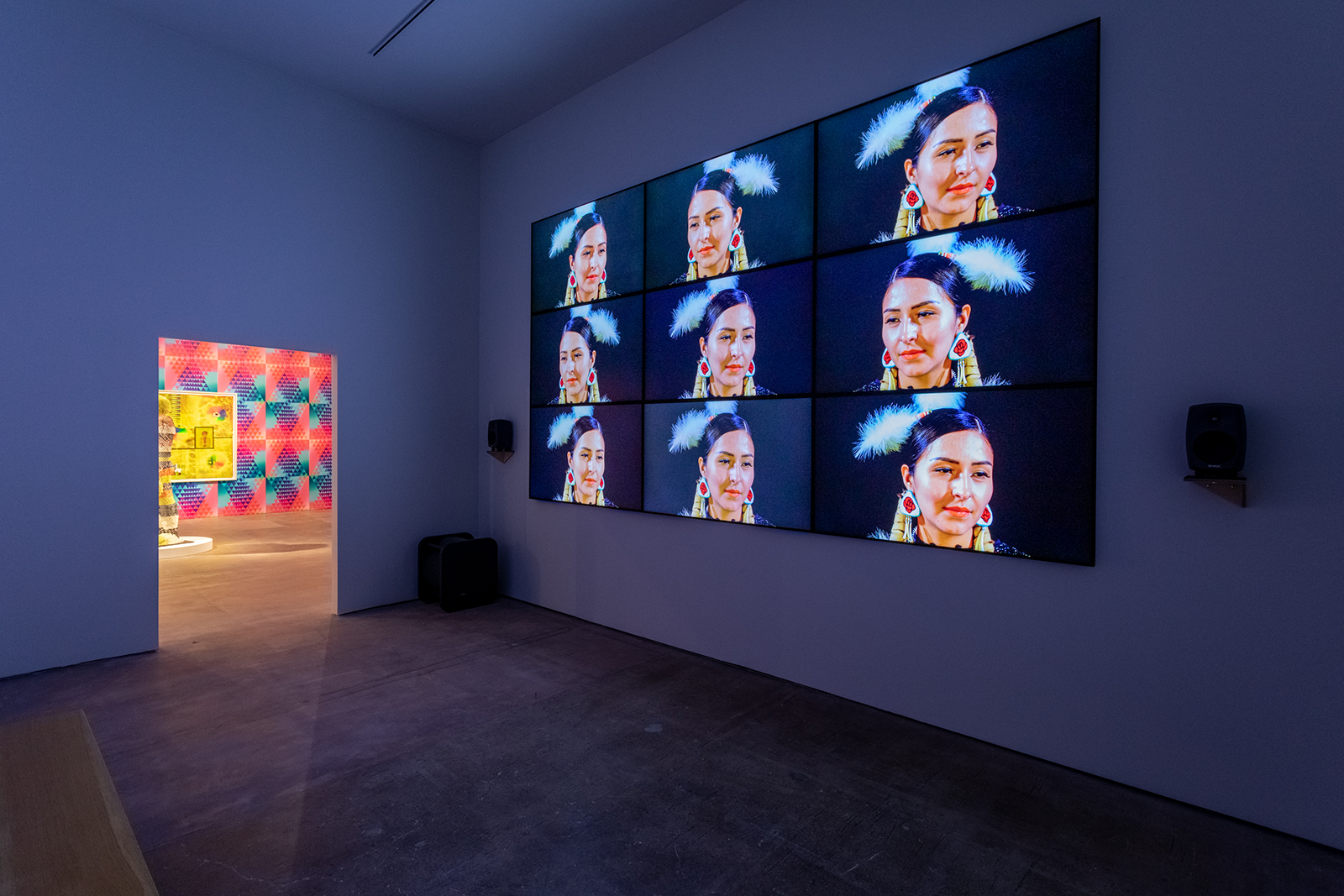 An empty gallery showcases a work featuring a multiple profile shots of a Native American woman.