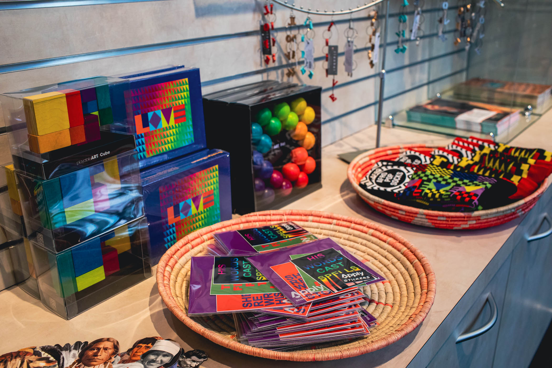 Colorful exhibition-related gifts displayed on gift shop table