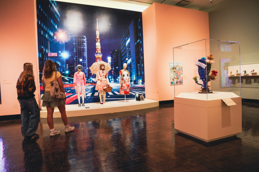 Two women looking at a display of Japanese young fashion.