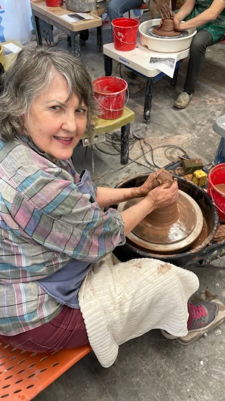 Susan DeMay throwing a pot on a wheel