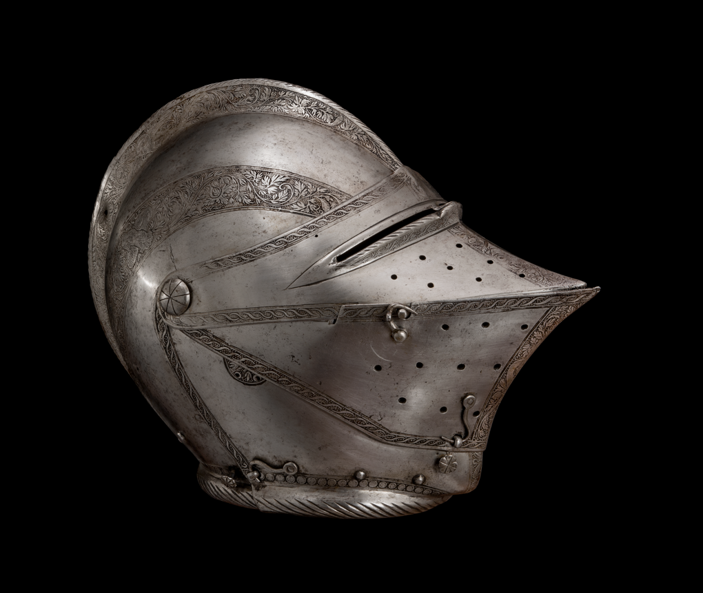 Side view of a full cover metal helmet with small eye slits and a beak shaped nose