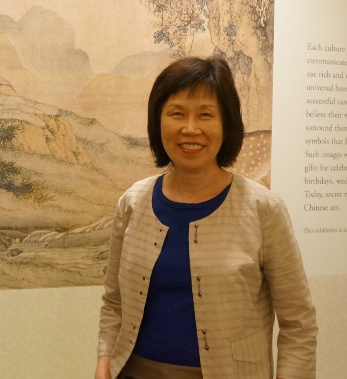 Ling-en Lu in front of a work of Chinese art