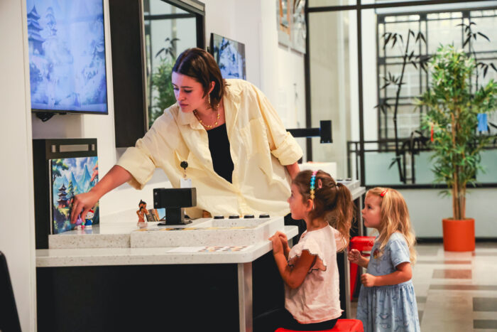 Mom and two daughters working at the animation station