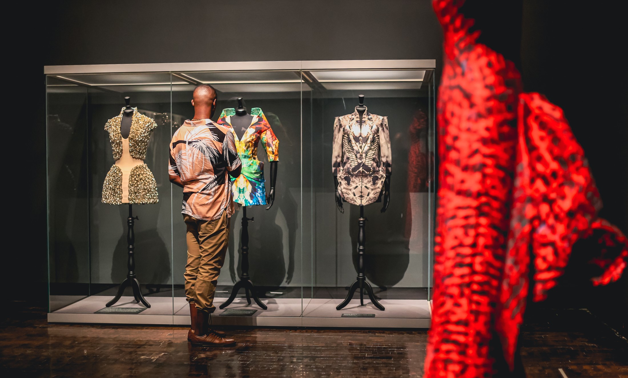 Man looking at garment in a case