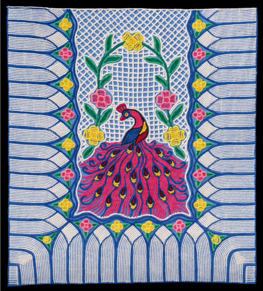 Colorful quilt with pink peacock in the middle with flowers surrounding it.