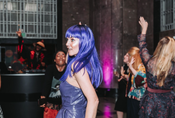 Young woman with purple hair dancing